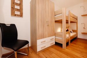 a bedroom with a desk and a chair and bunk bed at Apartment Marent Garten Chalet in Vandans