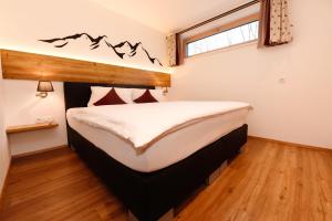 a bedroom with a large bed in a room at Apartment Marent Garten Chalet in Vandans