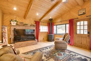 a living room with a fireplace and a tv at Creekside Ten Sleep Vacation Rental and Deck and Grill in Ten Sleep