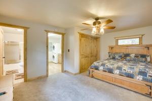 a bedroom with a bed and a ceiling fan at Creekside Ten Sleep Vacation Rental and Deck and Grill in Ten Sleep