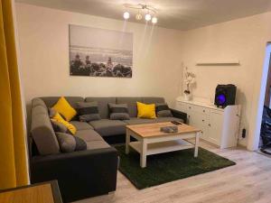 a living room with a couch and a table at Apartmán ROSE in Martin