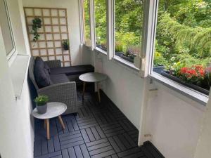 a balcony with two windows and a table and chairs at Apartmán ROSE in Martin