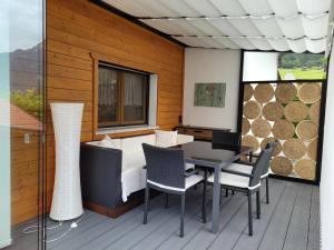 a room with a bed and a table and chairs at Alpenglück Montafon in Sankt Gallenkirch