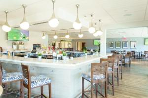 a restaurant with a bar with wooden chairs at Fairfield Inn & Suites by Marriott Fort Lauderdale Northwest in Tamarac