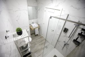 a bathroom with a shower and a toilet and a sink at Atico Casa Lola in Córdoba