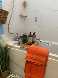a bathroom with two towels on a bath tub at Salcombe View in Kingsbridge