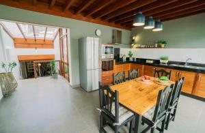 a kitchen with a wooden table and chairs in a kitchen at CASA EMBLEMÁTICA MARUCA y LELI in Los Silos