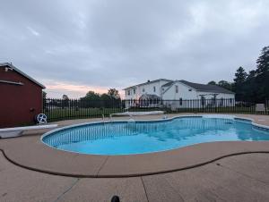 a swimming pool in a yard with a house at The Parrsboro Mansion Inn in Parrsboro