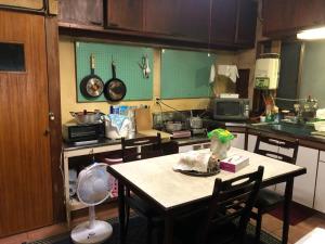 a kitchen with a table with a fan in it at Minpaku Togenkyo 2 - Vacation STAY 15096 in Toba