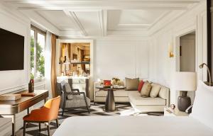 a living room with a couch and a table at Rosewood Villa Magna in Madrid