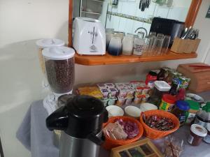 a kitchen counter with a blender and some food at Hostal Campo Base in San Pedro de Atacama