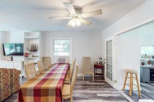a dining room with a table and a ceiling fan at Calloway Drive Retreat in Deale