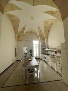a large kitchen with a table and chairs in it at Historic Room in Noha