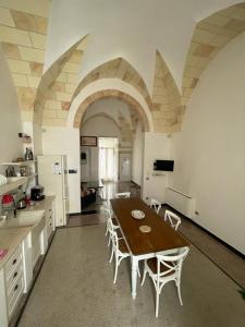 a large kitchen with a table and chairs in it at Historic Room in Noha