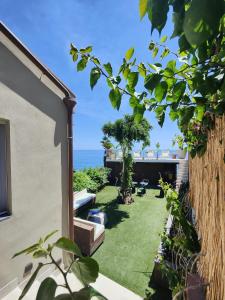 a garden with a view of the ocean at Luxury B&b Euphorbia in Acireale