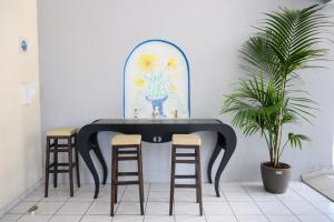 a table with two stools and a table with a table at Sunrise1 in Paralia Katerinis
