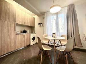 a kitchen with a table and chairs in a room at Chic Studio in Timişoara