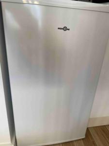 a white refrigerator freezer sitting in a room at Aix-les Bains in Aix-les-Bains