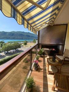 a balcony with an umbrella and a view of the ocean at Aix-les Bains in Aix-les-Bains