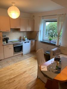 a kitchen and living room with a table and a window at Apartment close to the center + free parking in Oldenburg