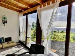 a room with a window with a view of the ocean at Nature Finca Apartment - Pure Relaxation in Mazo