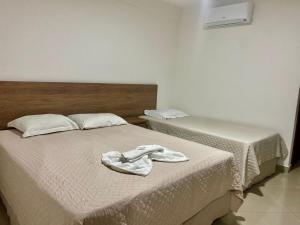 Postel nebo postele na pokoji v ubytování Hotel Skalla - MELHOR CUSTO BENEFICIO