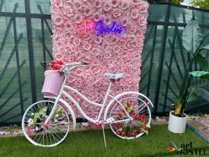 a pink bike parked in front of a wall of flowers at Summer Gardens in Miami +49 photos
