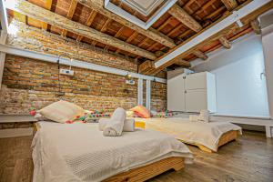 two beds in a room with a brick wall at Frida Salou ONLY FAMILIES in Salou