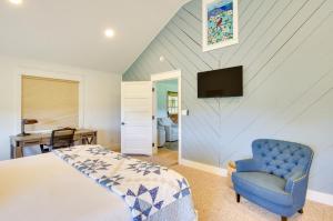 ein Schlafzimmer mit einem Bett und einem blauen Stuhl in der Unterkunft Modern Altavista Farmhouse with Countryside Views in Altavista