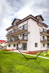 a building with a lawn in front of it at Vila Kos in Mamaia Sat/Năvodari