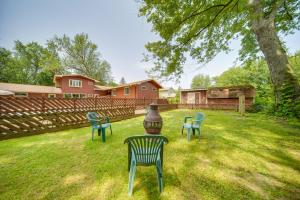 a yard with chairs and a vase in the grass at Lake Erie Getaway with Private Pool and Yard! in Conneaut