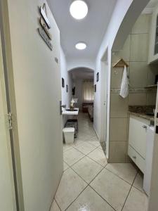 a bathroom with a sink and a toilet in a room at Hotel Cavalinho Branco - Apartamento 516 in Águas de Lindóia