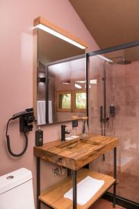 a bathroom with a sink and a shower at Las Qolqas EcoResort Ollantaytambo in Ollantaytambo