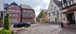 a car parked on a street in a town with buildings at Ferienwohnung am Kirchberg Europa-Park Spassbad-Rulantica-Schwarzwald ,Frankreich, in Ettenheim