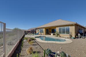a house with a swimming pool in front of a fence at Tucson Home with Private Pool and Mountain Views! in Catalina