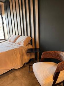 a bedroom with two beds and a table and a chair at Suites Isla Verde in La Rioja