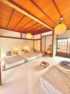 a large room with two beds and two lamps at 三丁庵ゲストハウス 紫陽花祭り会場まですぐ 観光地ペリーロードまですぐの最高なロケーション 下田を遊び尽くせるゲストハウス 無料駐車場もありますJapanese old style guest house that close to Perry road We have long stay plan in Harada