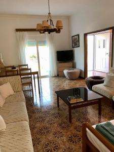 a living room with a couch and a coffee table at Lemon tree's house in Kalavárda