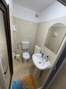 a bathroom with a sink and a toilet at Vila Lorena in Mangalia