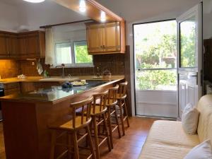 a kitchen with a island with bar stools at Lemon tree's house in Kalavárda +36 photos