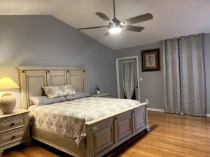 a bedroom with a bed and a ceiling fan at tropical bay house in Englewood