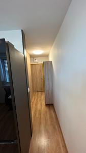 an empty room with two doors and a wooden floor at Apartman City Park Stráňany in Michalovce