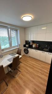 a kitchen with a table and chairs in a room at Apartman City Park Stráňany in Michalovce