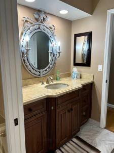 a bathroom with a sink and a mirror at tropical bay house in Englewood