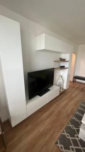 a living room with a large tv on a wall at Apartman City Park Stráňany in Michalovce