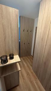 a room with wooden cabinets and a room with wooden floors at Apartman City Park Stráňany in Michalovce