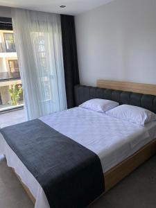 a large bed in a bedroom with a window at No 22 Çeşme in Çeşme