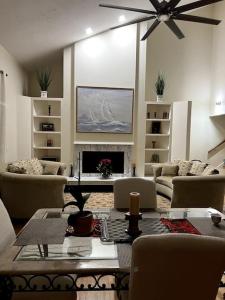 a living room with a table and chairs and a fireplace at tropical bay house in Englewood