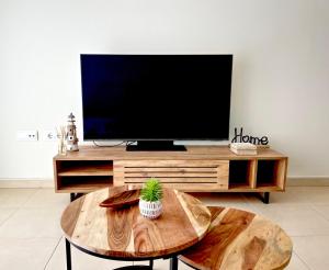 a living room with a tv and a coffee table at BORA BORA Ático con piscina privada en Vera Paraíso in Vera