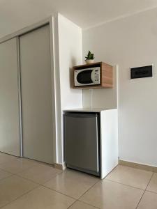 a kitchen with a microwave on top of a refrigerator at Edificio 9 de Julio in San Miguel de Tucumán